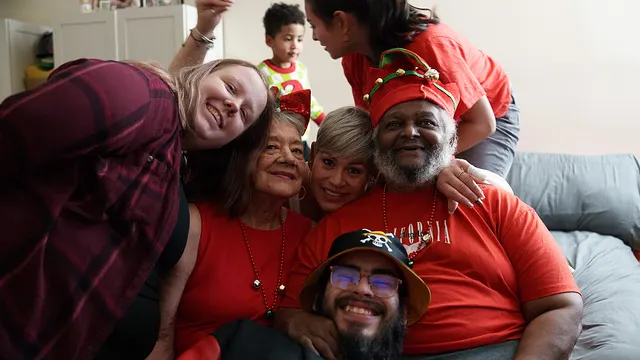 The whole family piled onto the sofa in red