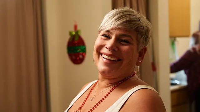 A woman laughing by the window