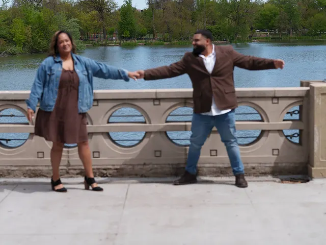 Arms out, holding hands across the bridge