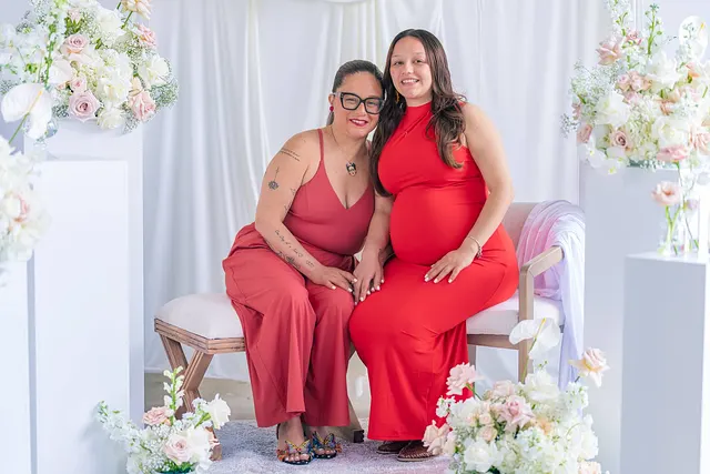 Two women on the bench, one expecting