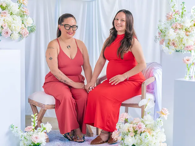 Two women in red on the bench