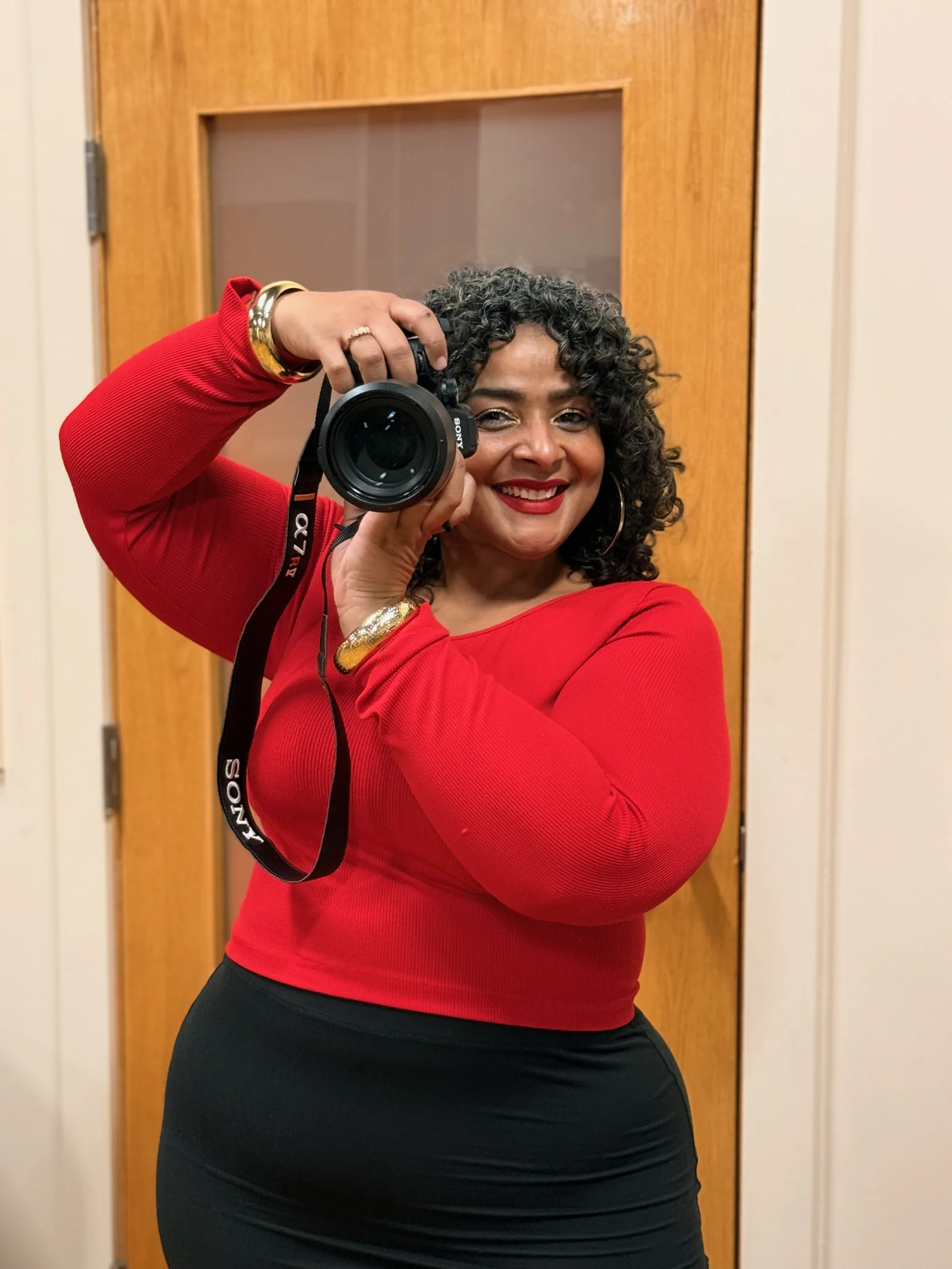 A smiling client in a red top holding Riri
