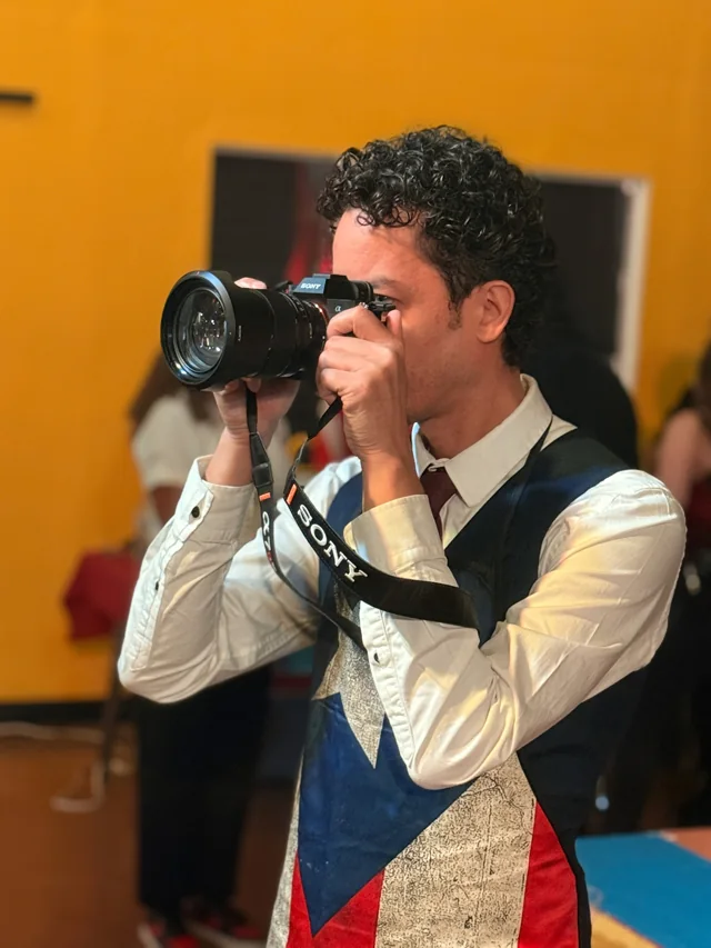 A client in a vest photographing with Riri
