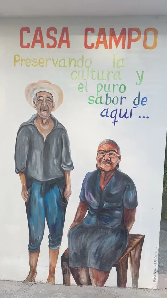 Two painted figures and the Casa Campo lettering on a mural.