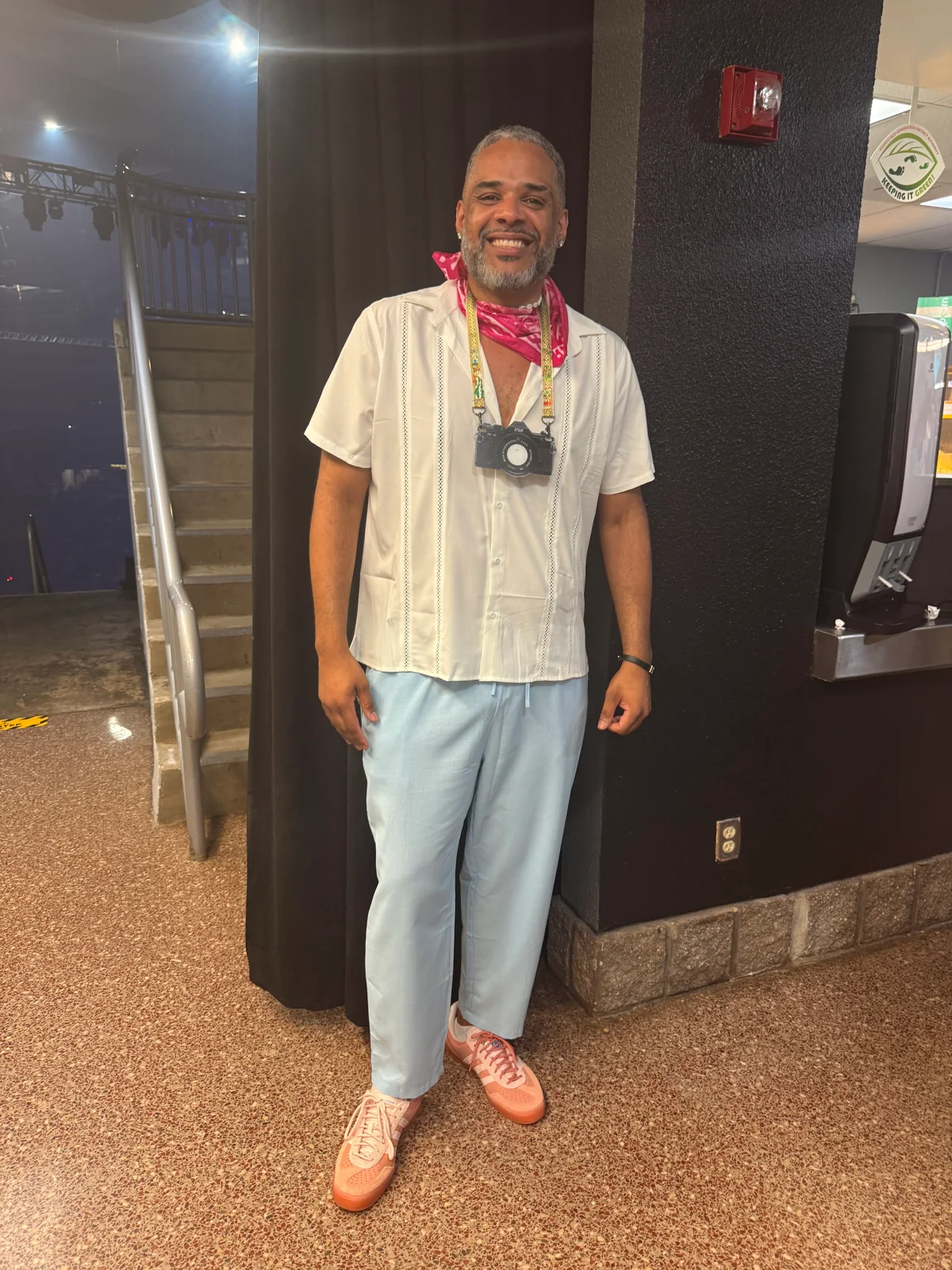 Falú in his concert outfit, with a camera around his neck.